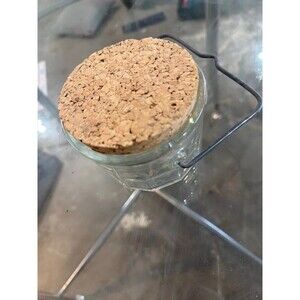 vintage faceted clear glass storage jar featuring a thick composition cork lid